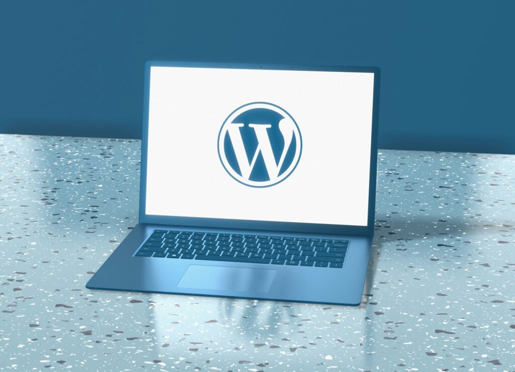 A computer sitting on a desk displaying the WordPress logo